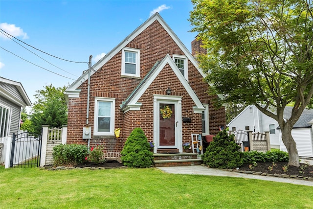 14 Kelly Ct, Kings Park, NY 11754 - tudor-style house with brick siding and a gate