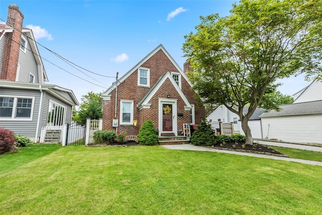 14 Kelly Ct, Kings Park, NY 11754 - tudor-style house featuring a gate and brick siding