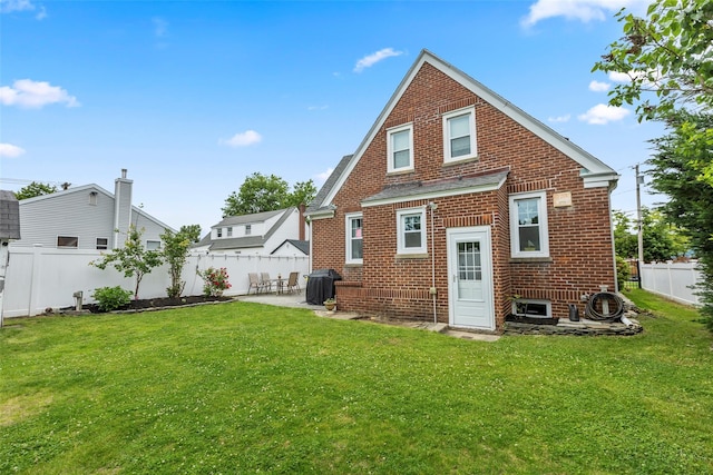 14 Kelly Ct, Kings Park, NY 11754 - rear view of house with brick siding and a patio