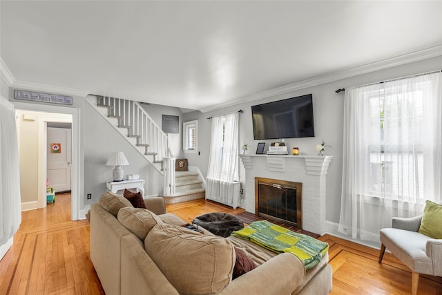 14 Kelly Ct, Kings Park, NY 11754 - living area with stairs, a brick fireplace, crown molding, radiator, and baseboards