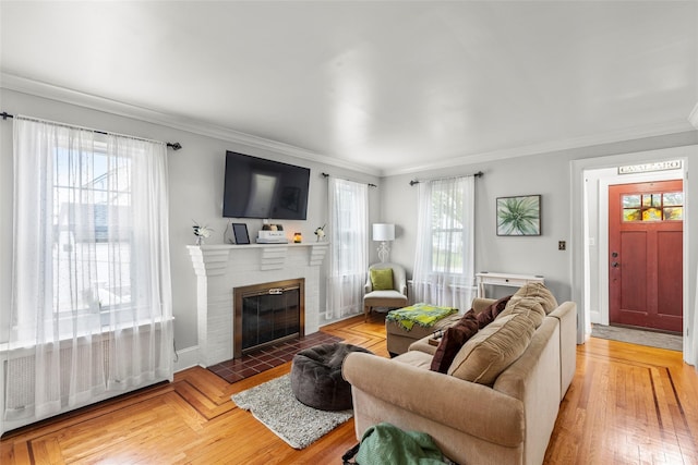 14 Kelly Ct, Kings Park, NY 11754 - living area featuring a fireplace, crown molding, baseboards, and light wood finished floors