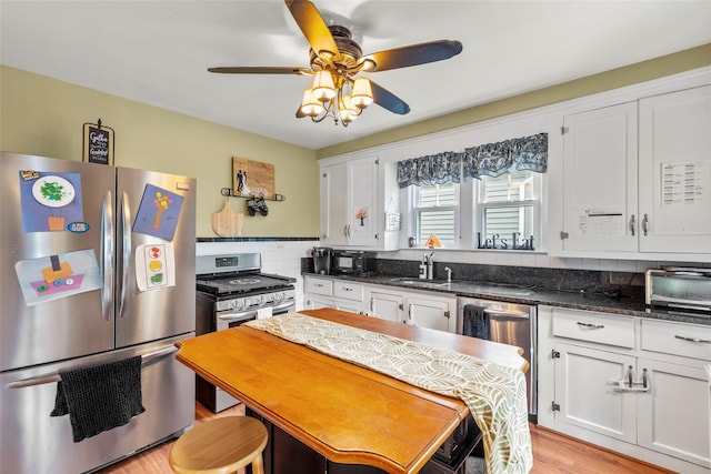 14 Kelly Ct, Kings Park, NY 11754 - kitchen featuring appliances with stainless steel finishes, a sink, and white cabinetry