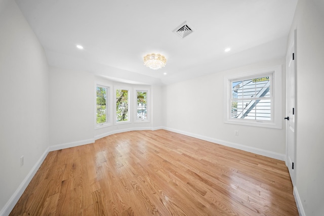 spare room with recessed lighting, baseboards, light wood finished floors, and visible vents