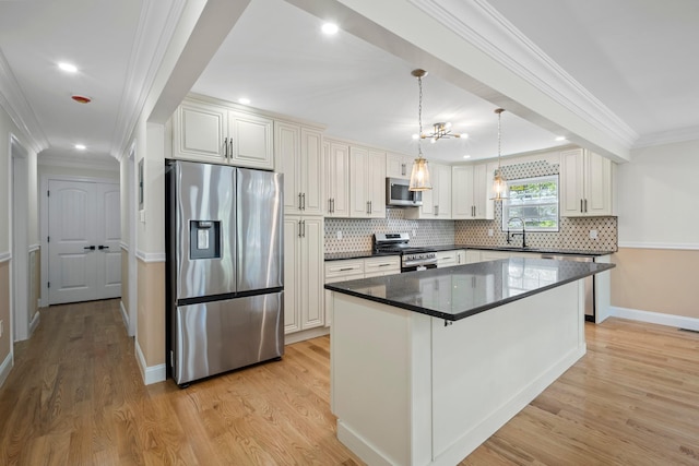 kitchen featuring decorative backsplash, appliances with stainless steel finishes, ornamental molding, and light wood-style flooring