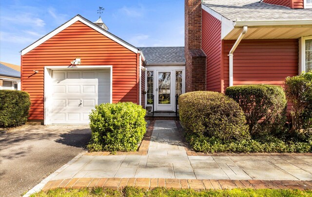 view of front of property with a shingled roof and a chimney