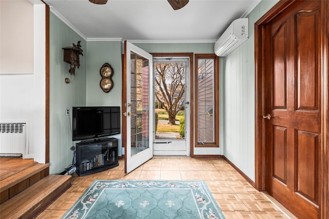 entrance foyer with ornamental molding, a ceiling fan, radiator heating unit, and a wall unit AC