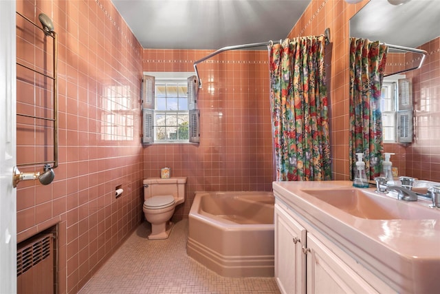 bathroom featuring radiator heating unit, vanity, tile walls, toilet, and tile patterned flooring