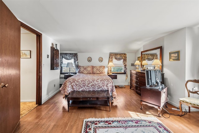 bedroom with baseboards and wood finished floors