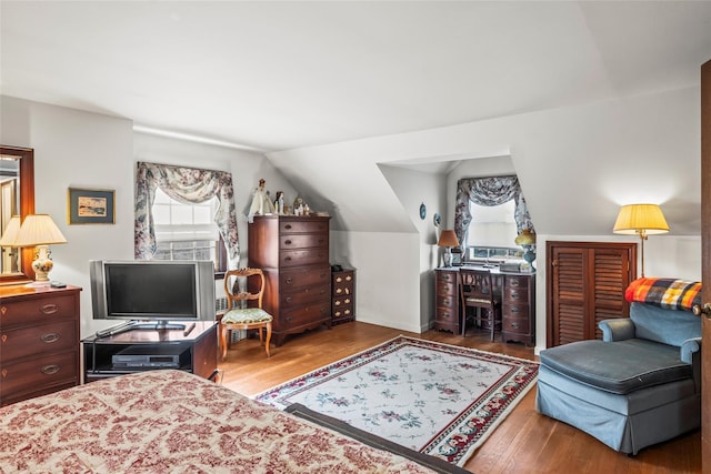 bedroom featuring vaulted ceiling and wood finished floors