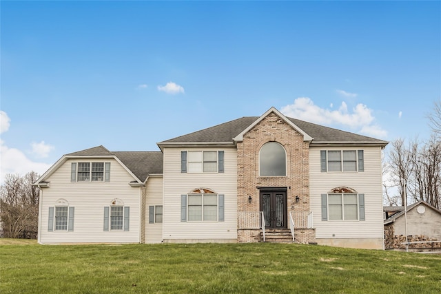146 Duke Dr, Carmel, NY 10512 - colonial home featuring a shingled roof, french doors, a front yard, and brick siding