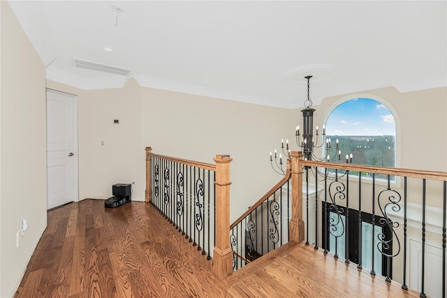 146 Duke Dr, Carmel, NY 10512 - hallway with a notable chandelier, wood finished floors, an upstairs landing, ornamental molding, and visible vents