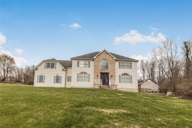 146 Duke Dr, Carmel, NY 10512 - view of front facade featuring entry steps, roof with shingles, and a front lawn
