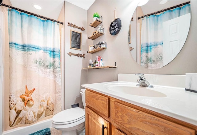 bathroom featuring toilet, vanity, and curtained shower