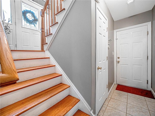 stairway featuring tile patterned floors and baseboards