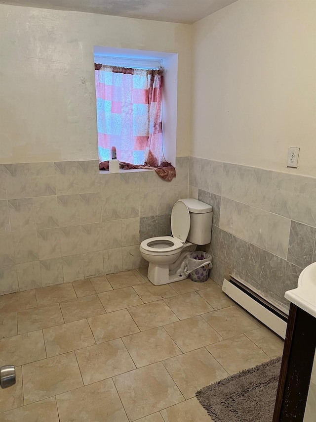 3412 Hunter Ave, Bronx, NY 10475 - half bathroom featuring baseboard heating, tile patterned floors, toilet, wainscoting, and tile walls