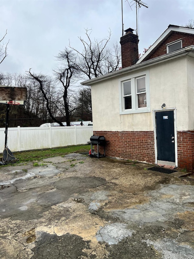 3412 Hunter Ave, Bronx, NY 10475 - view of home's exterior with stucco siding, fence, and brick siding