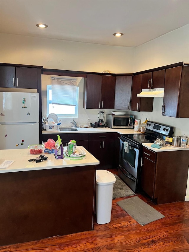 3412 Hunter Ave, Bronx, NY 10475 - kitchen featuring stainless steel appliances, under cabinet range hood, dark wood-type flooring, and dark brown cabinets