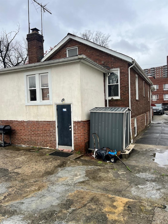 3412 Hunter Ave, Bronx, NY 10475 - back of property featuring brick siding, stucco siding, and a chimney