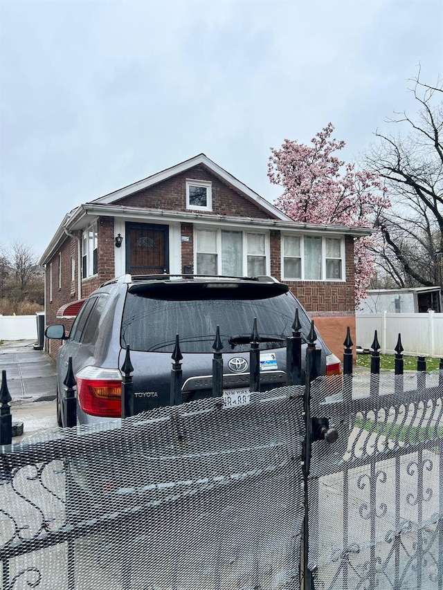 3412 Hunter Ave, Bronx, NY 10475 - view of front of house with brick siding and a fenced front yard