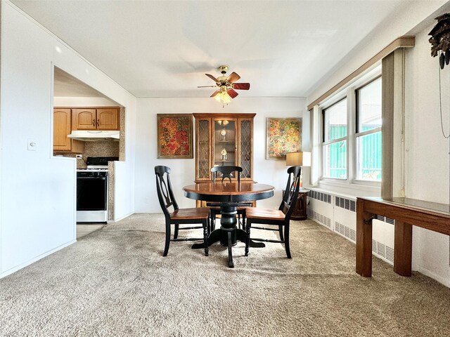 86-15 Broadway Unit 4D, Elmhurst, NY 11373 - dining room featuring radiator heating unit, light carpet, and a ceiling fan