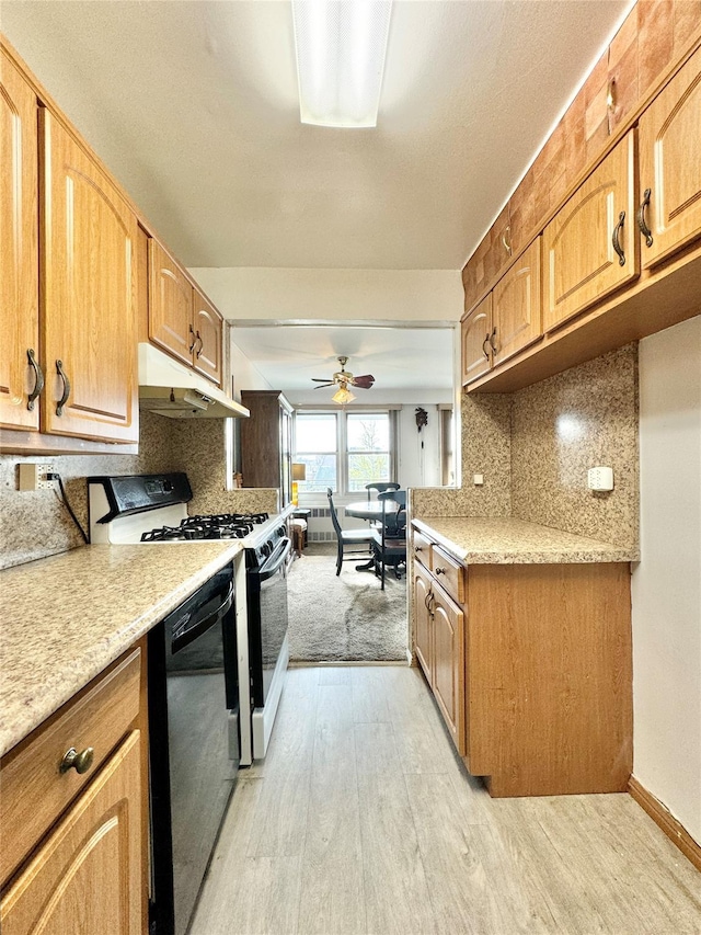 86-15 Broadway Unit 4D, Elmhurst, NY 11373 - kitchen with light wood-type flooring, black dishwasher, gas range oven, light countertops, and under cabinet range hood