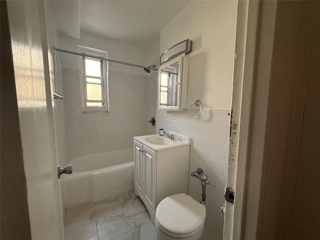 34-15 74th St Unit 4H, Jackson Heights, NY 11372 - bathroom with vanity, tile walls, toilet, washtub / shower combination, and marble finish flooring