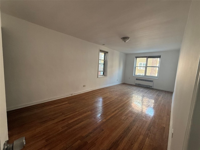 34-15 74th St Unit 4H, Jackson Heights, NY 11372 - unfurnished room featuring radiator heating unit, dark wood-style flooring, and baseboards