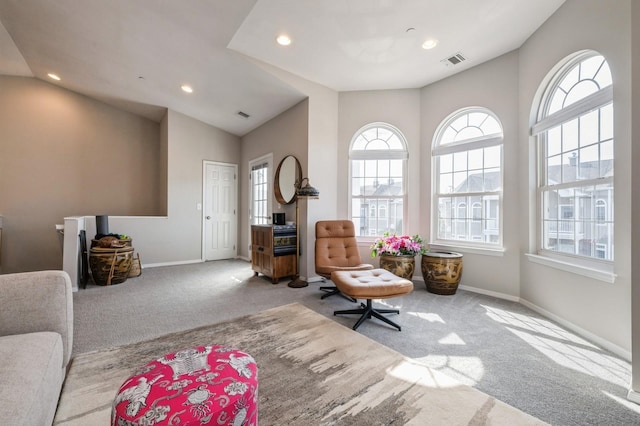 sitting room with a wealth of natural light, carpet flooring, and visible vents