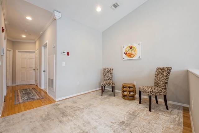 sitting room featuring visible vents, baseboards, and wood finished floors