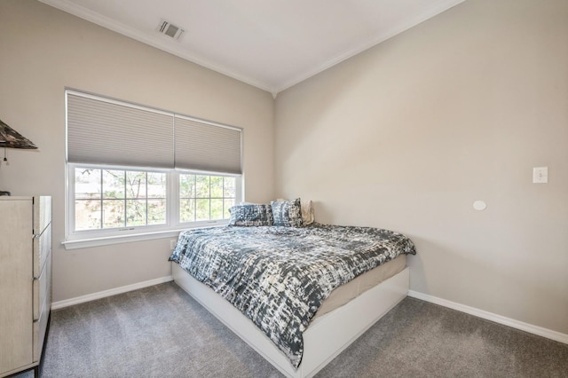 carpeted bedroom featuring visible vents, baseboards, and ornamental molding