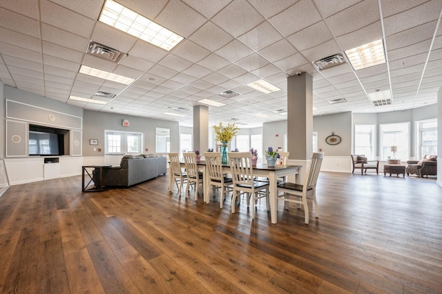 dining space with visible vents, a drop ceiling, and wood-type flooring