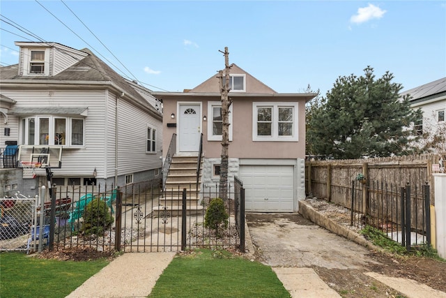 425 Quincy Ave, Bronx, NY 10465 - view of front of property featuring an attached garage, aphalt driveway, stucco siding, and fence