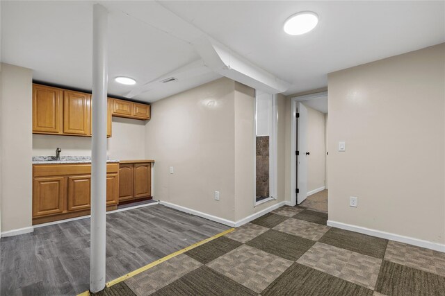 425 Quincy Ave, Bronx, NY 10465 - finished basement with a sink, baseboards, dark wood-style floors, and visible vents