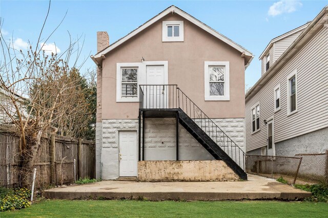 425 Quincy Ave, Bronx, NY 10465 - rear view of house with a chimney, stucco siding, and fence