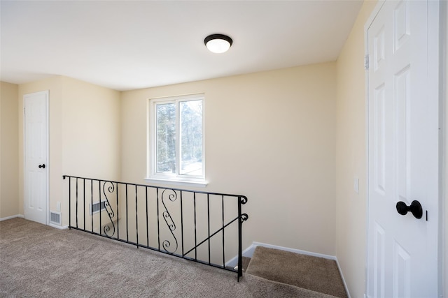 staircase with carpet, visible vents, and baseboards