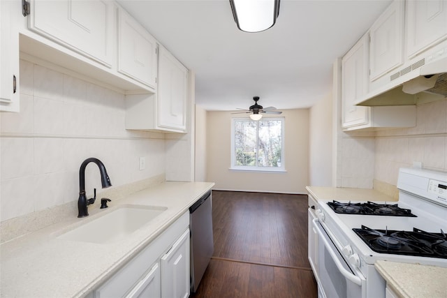 kitchen featuring backsplash, light countertops, dishwasher, a sink, and white gas range oven