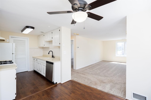 kitchen featuring light countertops, visible vents, a sink, white appliances, and white cabinetry