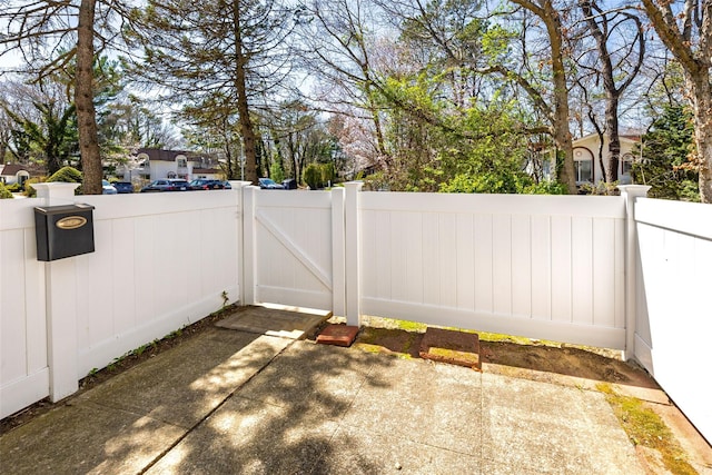 view of patio with a gate and fence