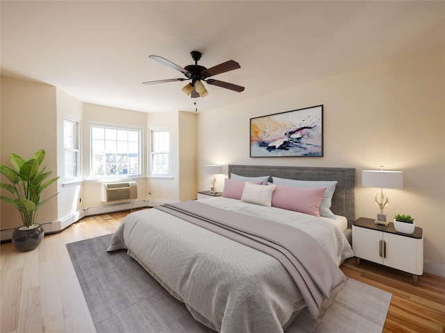 bedroom featuring baseboards, wood finished floors, and a wall mounted air conditioner