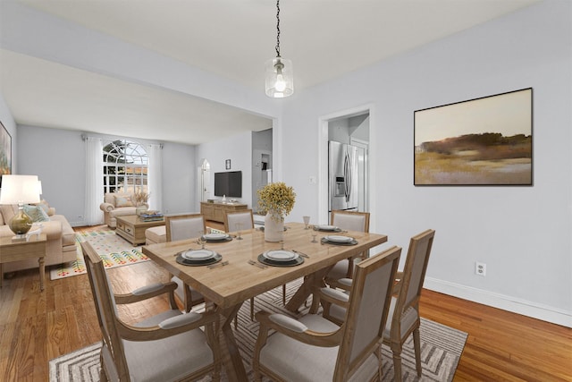 dining room featuring baseboards and wood finished floors