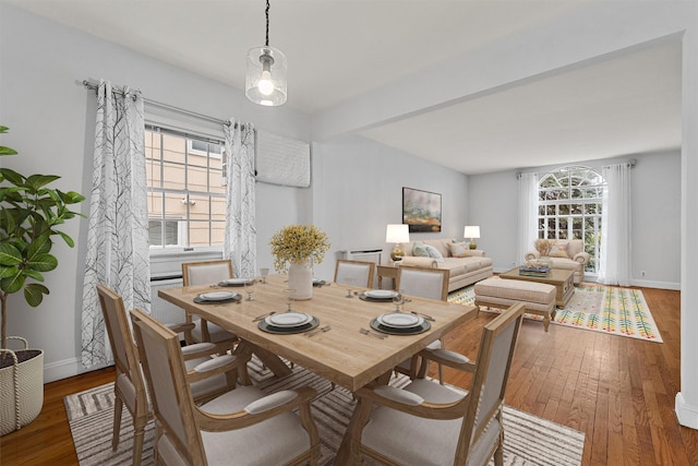 dining area featuring plenty of natural light, baseboards, and hardwood / wood-style floors