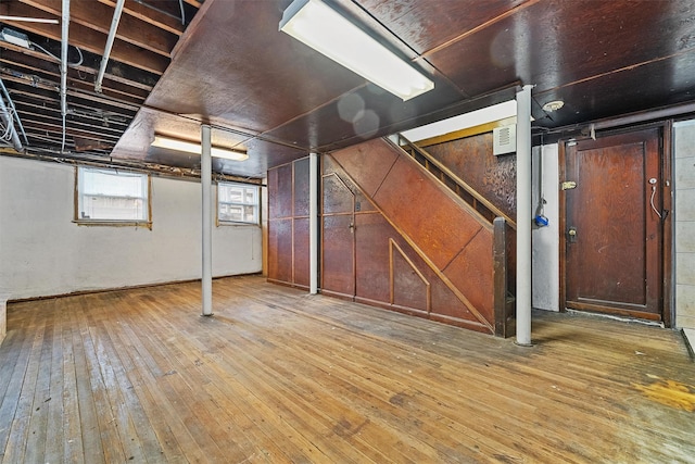 below grade area featuring visible vents and hardwood / wood-style flooring