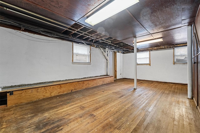 below grade area with hardwood / wood-style flooring