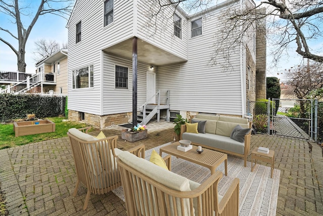 view of patio / terrace featuring outdoor lounge area, fence, and a gate