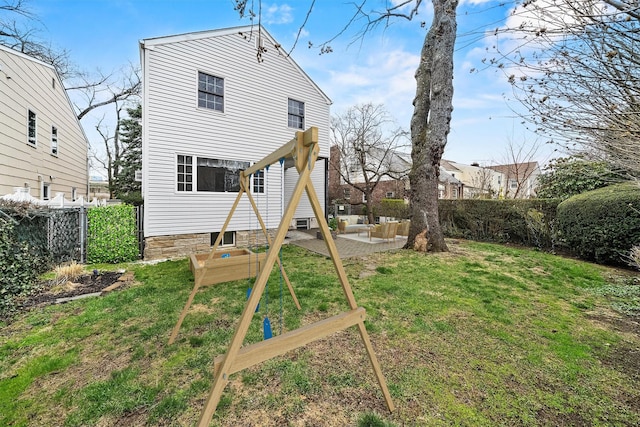 rear view of house featuring a patio, fence private yard, a lawn, and an outdoor hangout area