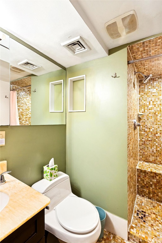 full bathroom with visible vents, a tile shower, and toilet