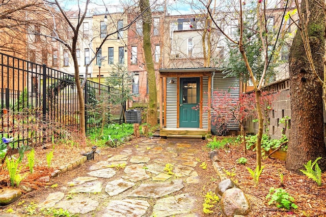 view of exterior entry featuring fence and central AC