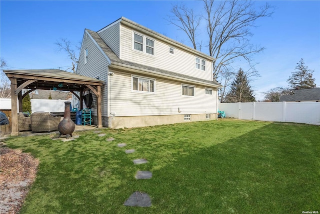 24 Southwood Ln, North Babylon, NY 11703 - back of house with a gazebo, a yard, and a fenced backyard