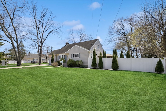 24 Southwood Ln, North Babylon, NY 11703 - view of side of home featuring a chimney, fence, and a yard