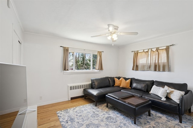 24 Southwood Ln, North Babylon, NY 11703 - living room featuring a ceiling fan, wood finished floors, ornamental molding, and radiator